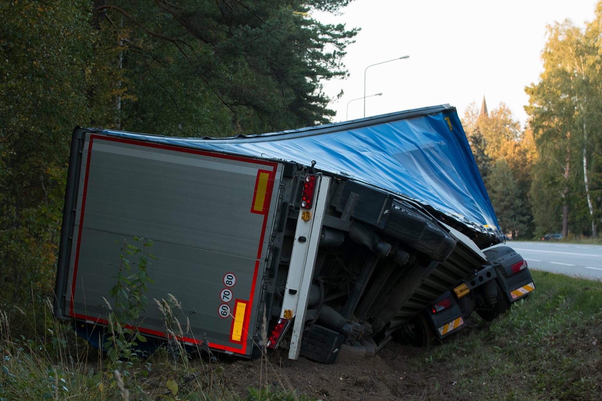 road accident lorry car crash on an highway lane road. Automobile in side ditch