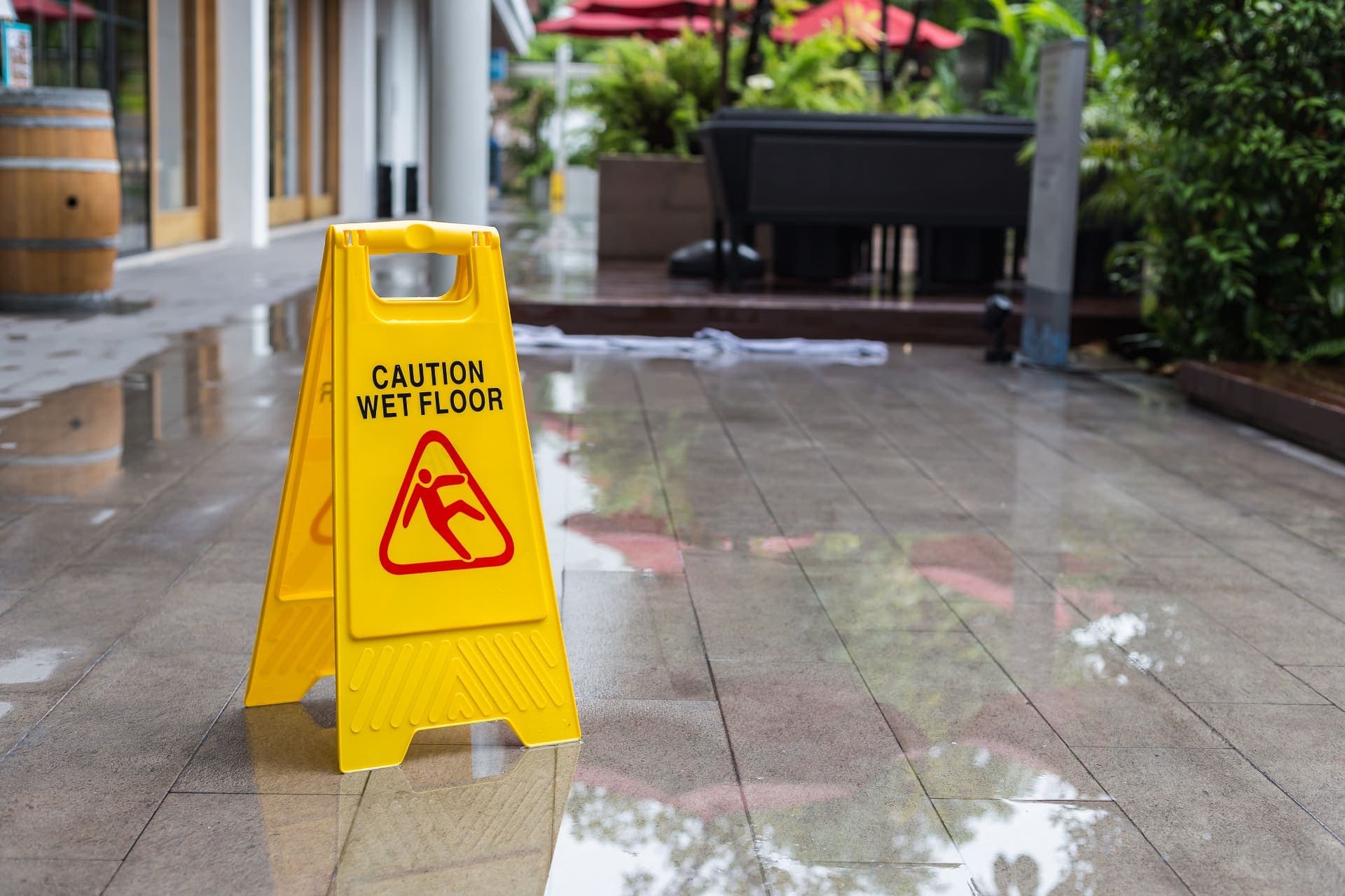 Yellow wet floor warning sign on the floor in hotel