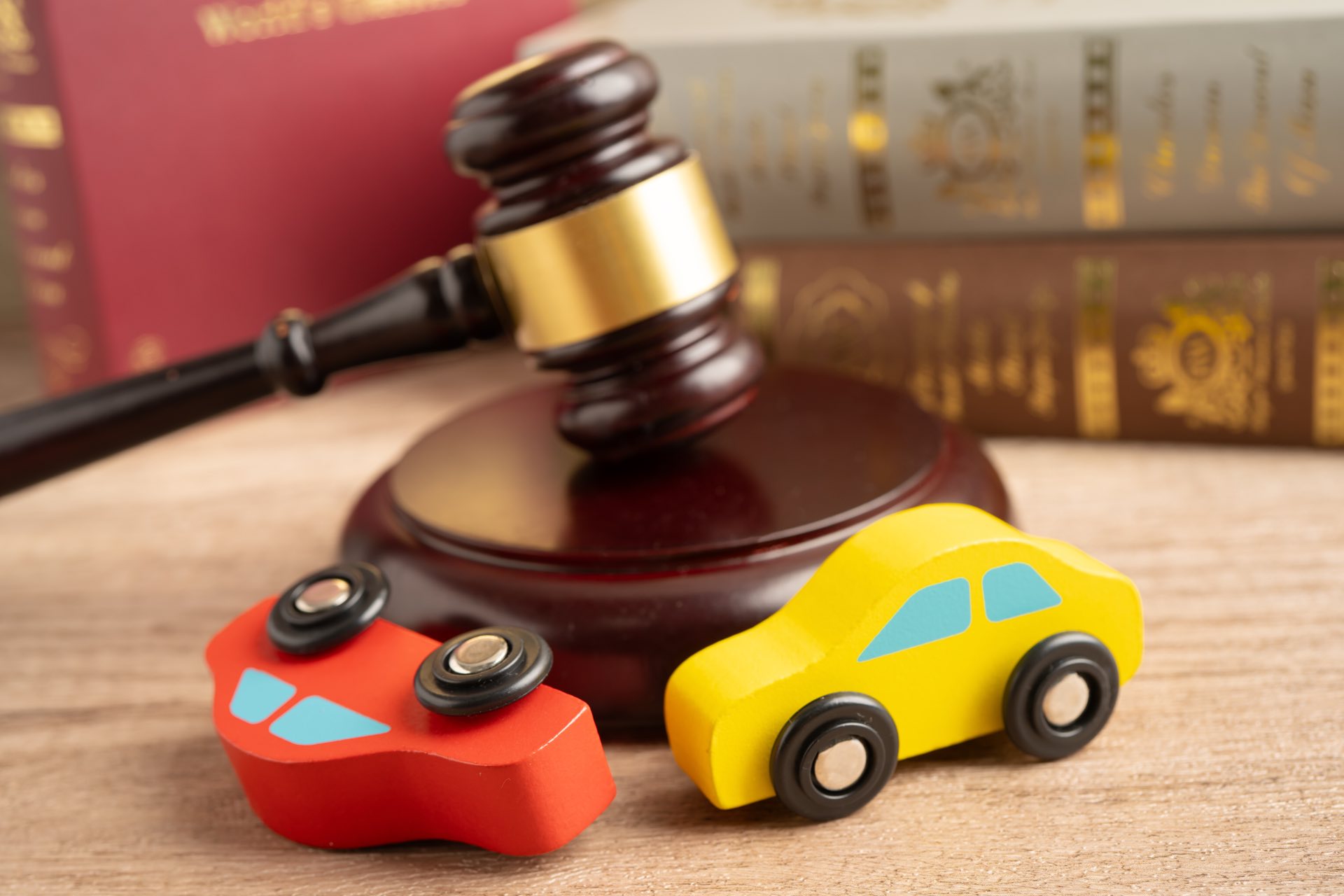 Two wooden vehicles next to a gavel
