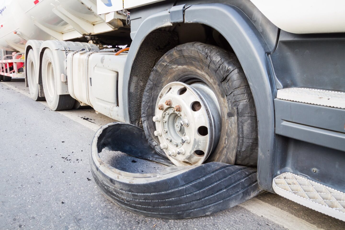 A closeup of a semi truck trie blowout