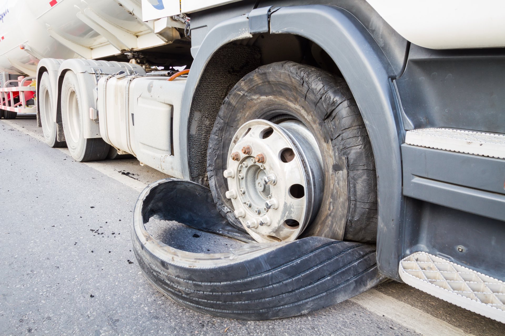 A closeup of a semi truck trie blowout