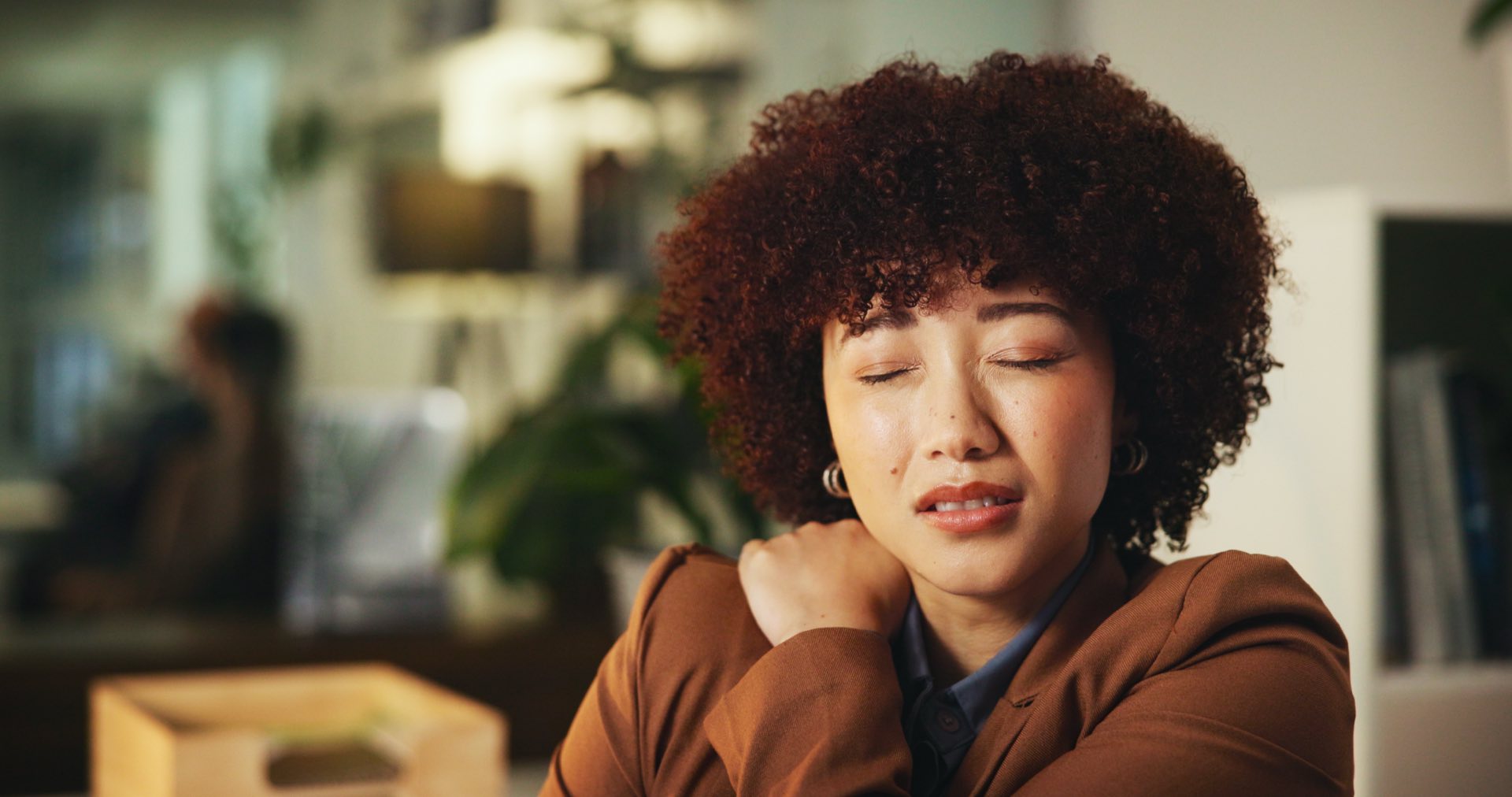 Woman holding her shoulder in pain