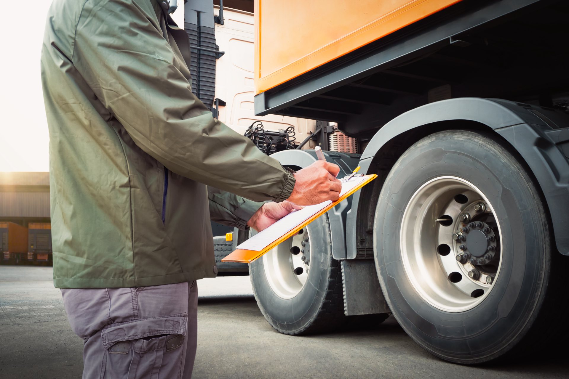 Truck Drivers Holding A Clipboard Checking Truck Wheels Tires. Semi Truck Tires. Maintenance Checklist. Inspection Safety Driving. Freight Truck Transport.