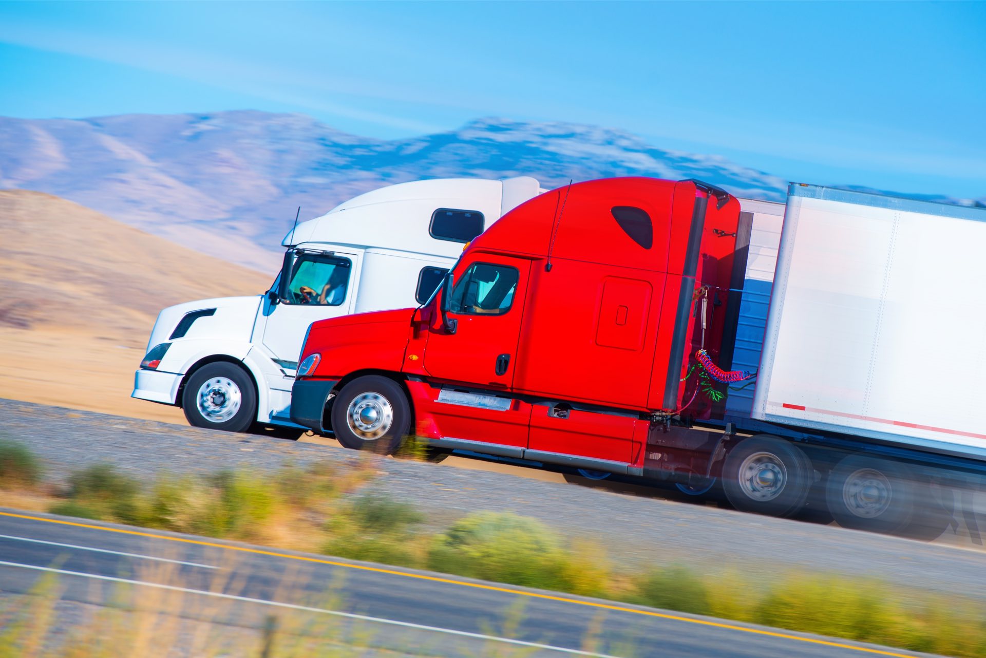 Two Speeding Semi Trucks on the Nevada Highway, USA. Trucking in America.