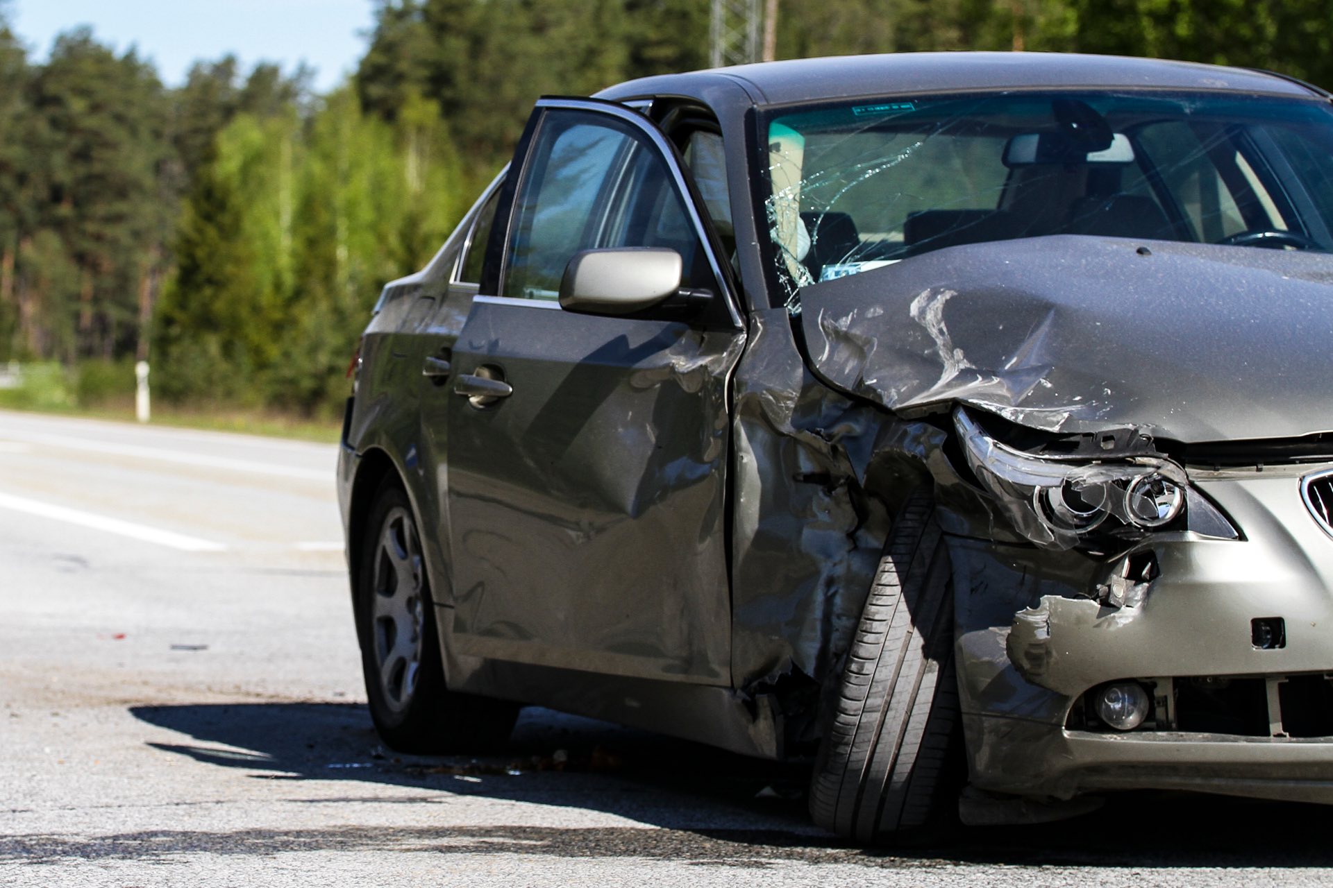 Grey vehicle in the road damage to front end