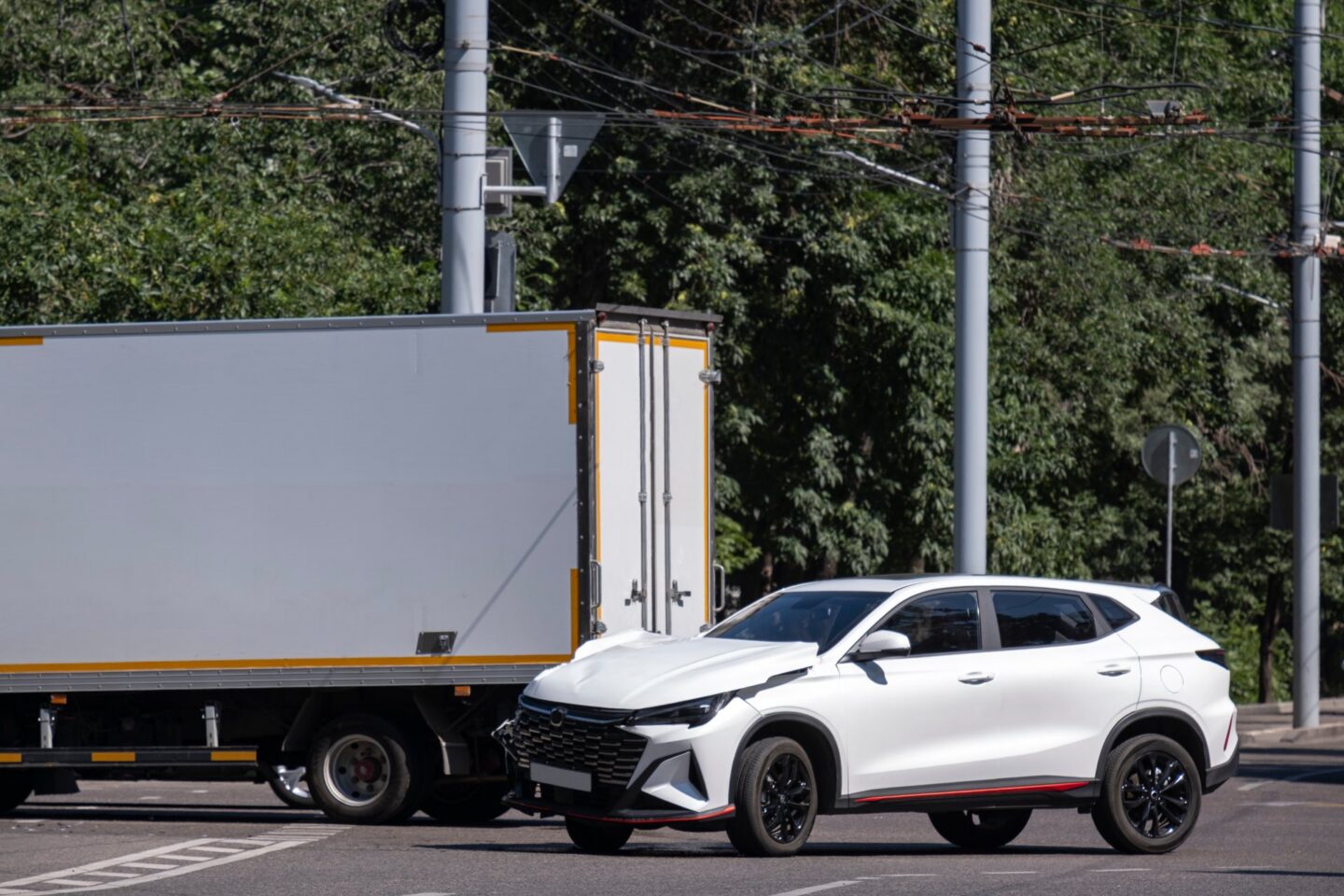A commercial truck and a white suv in an accident