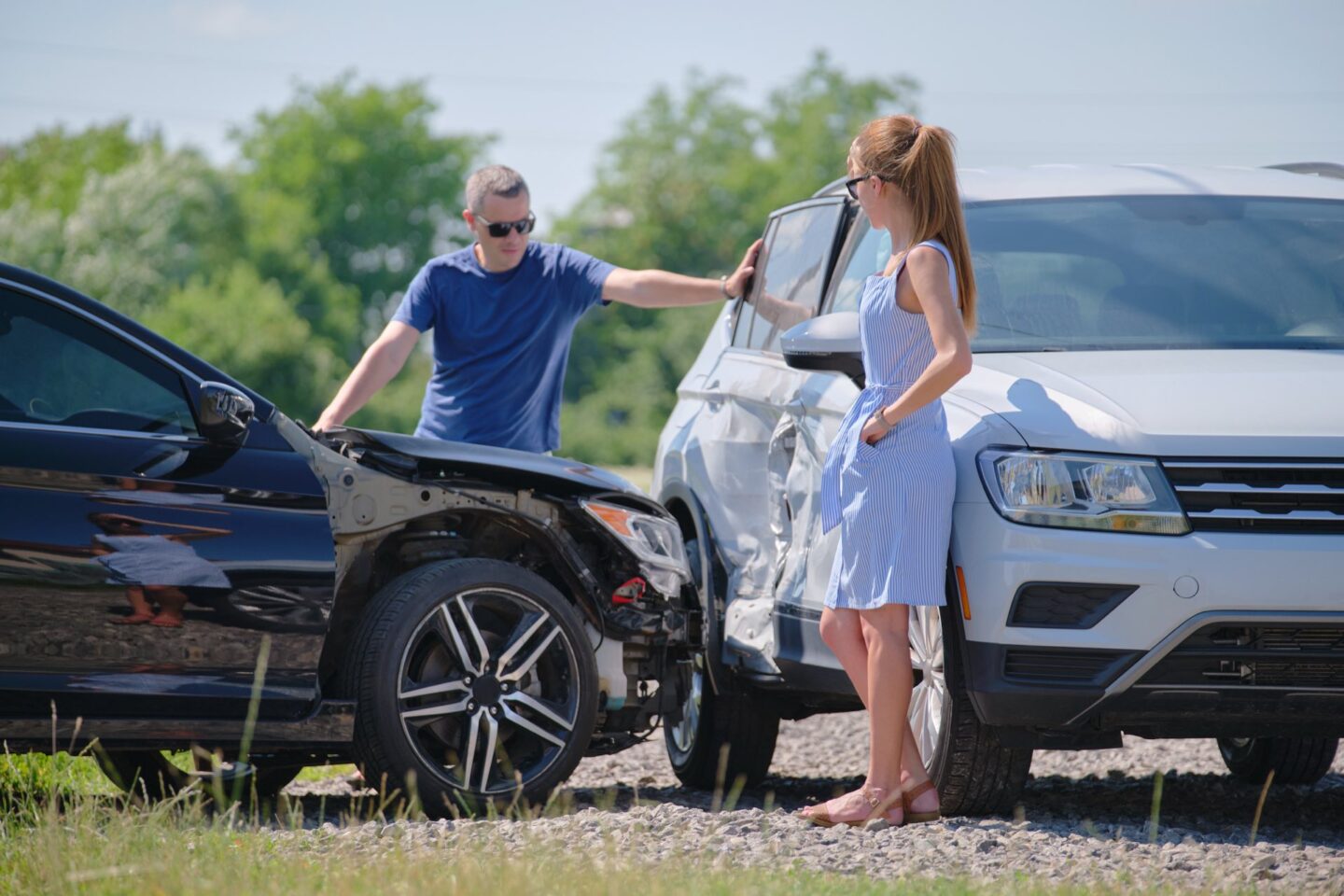 A black car hit a grey suv a man and woman standing by the cars