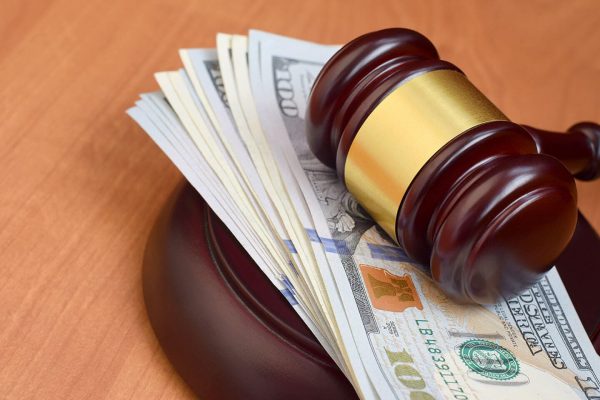 Legal gavel and injury compensation cash | personal injury law firm​ | Henderson Taylor Law Firm