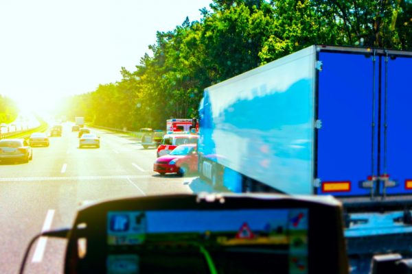 blue semi truck into an accident with red vehicle