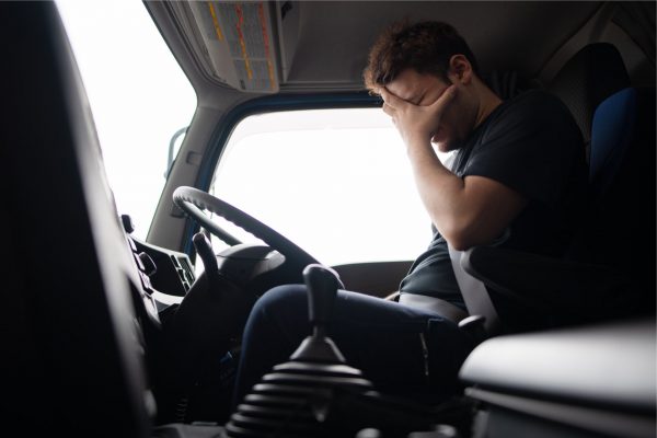 Fatigued truck driver behind the wheel | truck accident lawyer​ | Henderson Taylor Law Firm