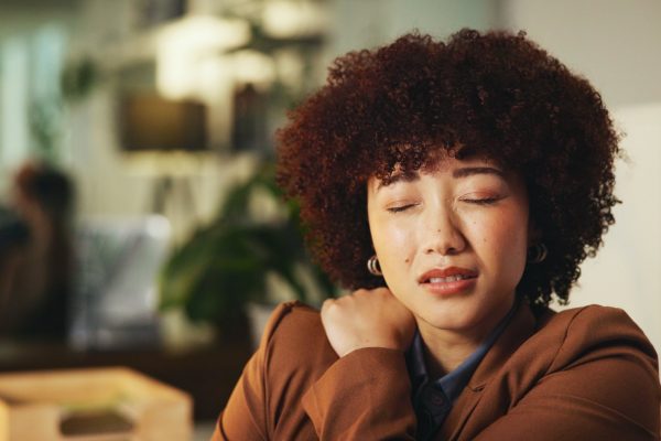 Woman holding her shoulder in pain